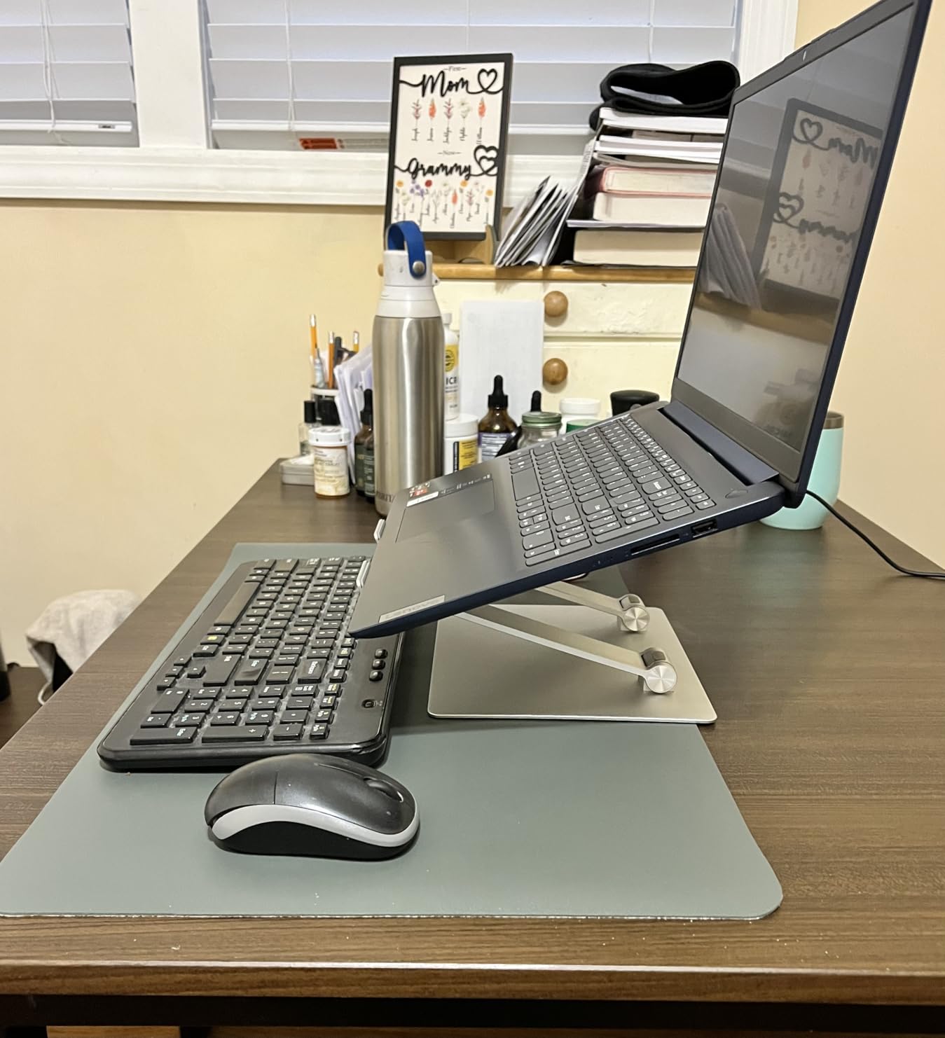 Amazon Basics Sturdy and Portable Ergonomic Laptop Stand for Desk, Height Adjustable Riser with Ventilated Cooling, Foldable, Fits all Laptops up to 17.3 Inch, Silver, 10 x 8.7 x 6 in customer photo 2