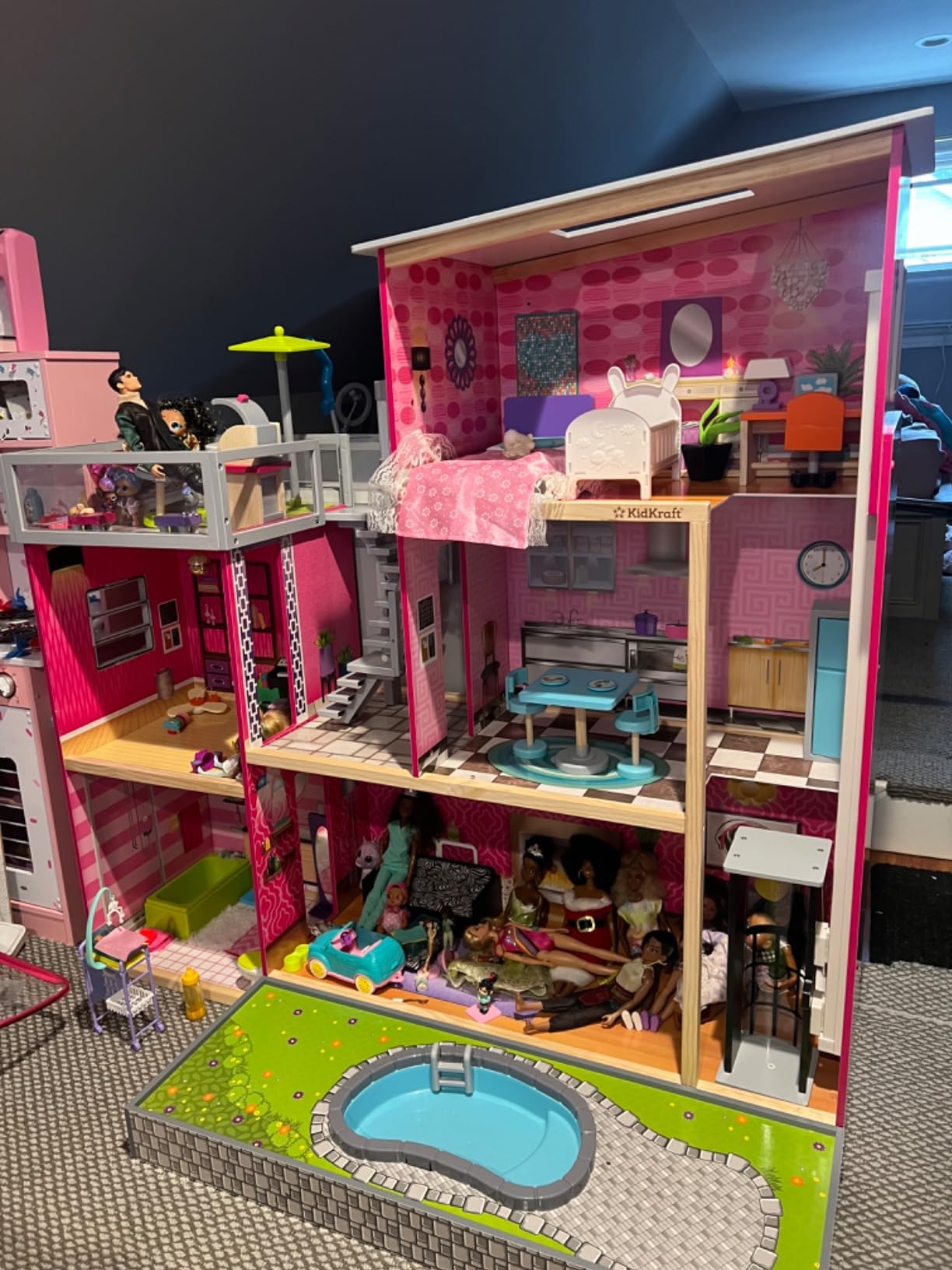 KidKraft Uptown Wooden Modern Dollhouse with Lights & Sounds, Pool and 36 Accessories | Over 3 Feet Tall Pink Mansion Doll House, Working Elevator, Rooftop Patio, For Dolls up to 12 Inches, Gift for Ages 3+ customer photo 2